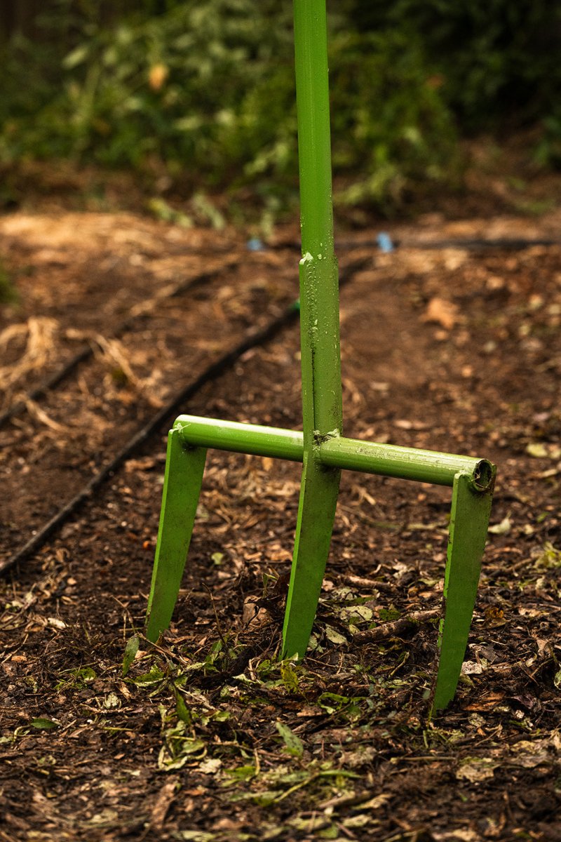 close up view of broadfork in garden setting