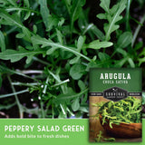 Arugula leaves with a seed packet labeled 'Survival Garden Seeds' on a green background.