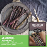 Purple asparagus on a plate with seed packet