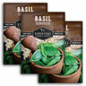 Survival Garden Seeds basil seed packets with basil leaves in pots.