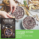 A product listing graphic for 'Lima Bean Jackson Wonder' seeds by Survival Garden Seeds. The image features a top photograph of hands preparing food with dried lima beans in bowls, a bottom-left inset showing the product's packaging, and a green text banner on the bottom right that reads 'SOUTHERN KITCHEN FAVORITE'.
