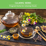 Tea set with herbs and flowers on a wooden table, promoting calming herbs for relaxing rituals.