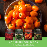 Bowl of bright orange peppers with seed packets labeled 'Hot Pepper Collection' on a wooden surface.