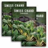 Three packages of Survival Garden Seeds Swiss Chard with green plants in the background.