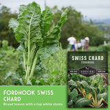 Fordhook Swiss Chard with Survival Garden Seeds packaging in a garden setting