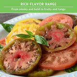 Sliced tomatoes on a plate with basil leaves, set against a green background with text about flavor range.