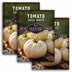 Three seed packets of 'Tomato Great White' with images of white tomatoes on a wooden surface.