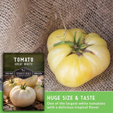 Great White tomato with Survival Garden Seeds packaging on a textured fabric background