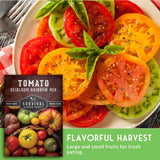 Sliced heirloom tomatoes on a plate with a package of Survival Garden Seeds Tomato Heirloom Rainbow Mix.