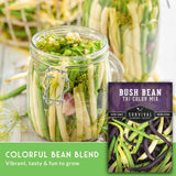 Jar of colorful beans with a package labeled 'Bush Bean Tri-Color Mix' on a wooden surface.