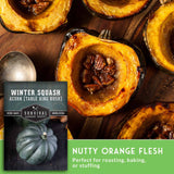 Roasted acorn squash with pecans on a wooden cutting board, accompanied by a seed packet for 'Survival Garden Seeds'.