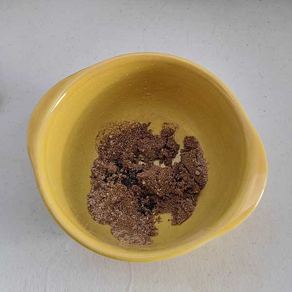 Yellow bowl with moist sand and flower seeds