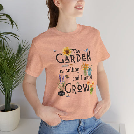 The Garden is Calling so I Must Grow Unisex Tee on female model - Peach
